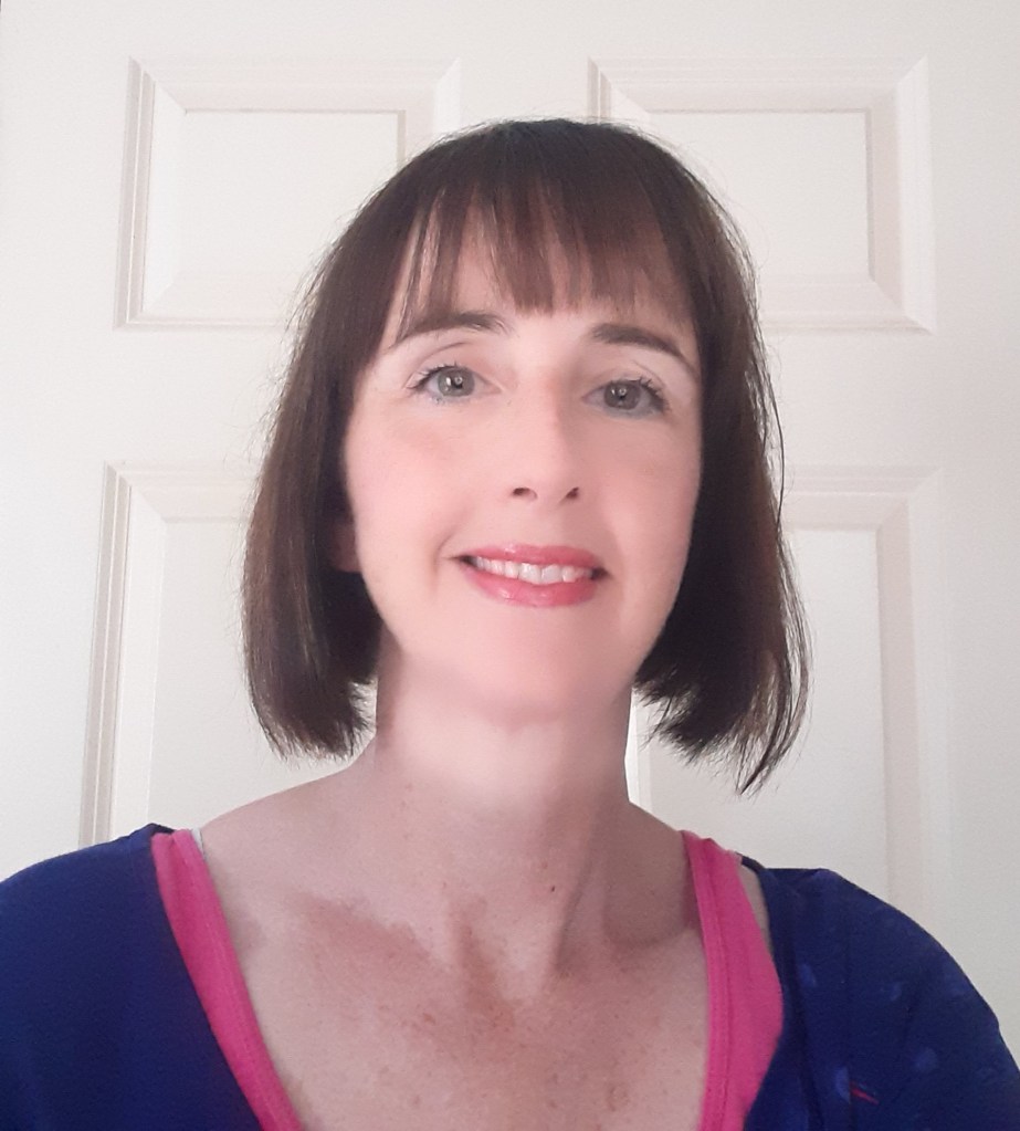 Geraldine O'Sullivan pictured against a white door.